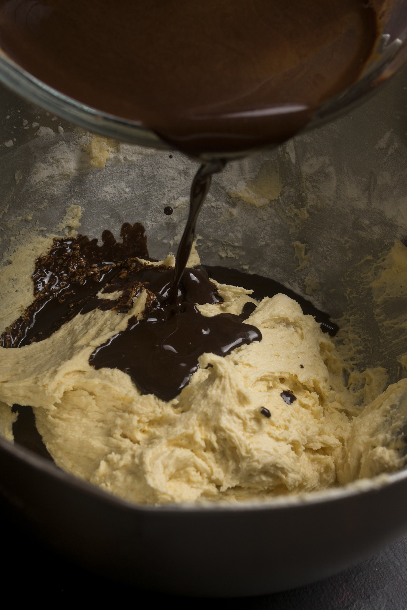 Chocolate cocoa and coffee mixture being poured into the cake batter.